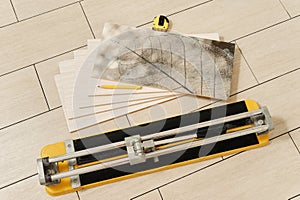 Ceramic tile, manual cutter, measuring tape and pencil