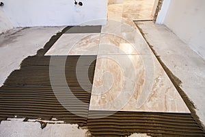 Ceramic tiles. Floor tiles installation. Home improvement, renovation - ceramic tile floor adhesive, mortar