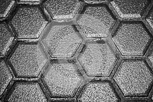 Ceramic tiles mosaic made of gray rhombuses, without grouting, the mesh-base and glue is visible. The concept of repair