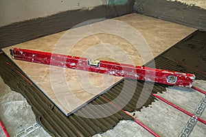 Ceramic tiles and tools for tiler. Floor tiles installation. Home improvement, renovation - ceramic tile floor