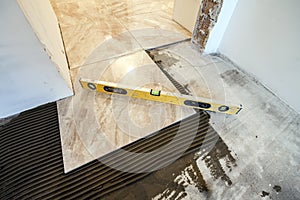 Ceramic tiles and tools for tiler. Floor tiles installation. Home improvement, renovation - ceramic tile floor