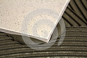 Ceramic tiles and tools for tiler. Floor tiles installation. Home improvement, renovation - ceramic tile floor adhesive,