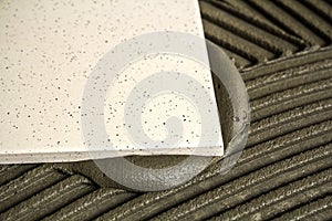 Ceramic tiles and tools for tiler. Floor tiles installation. Home improvement, renovation - ceramic tile floor adhesive,