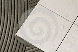 Ceramic tiles and tools for tiler. Floor tiles installation. Home improvement, renovation - ceramic tile floor adhesive