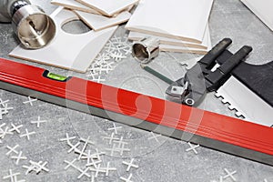 Ceramic tiles and tools for tiler, tiles installation. Home improvement, renovation - ceramic tile floor adhesive, mortar, level