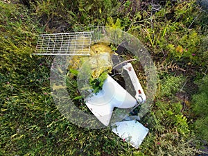 ceramic toilet bowl abandoned, garbage in the countryside