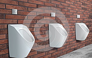 Ceramic urinals in men`s public bathroom