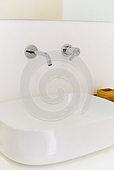 Ceramic Water tap sink with faucet with soap and towel in expensive loft bathroom or kitchen