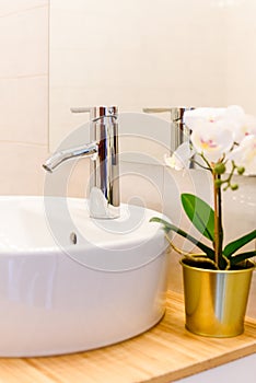 Ceramic Water tap sink with faucet withdecorative flower in expensive loft bathroom or kitchen