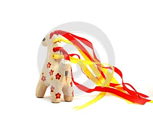 Ceramic whistle horse with a mane of yellow and red ribbons and painted with flowers isolated on a white background