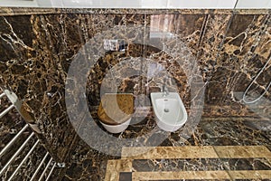 Ceramic white toilet and bidet with stone surface