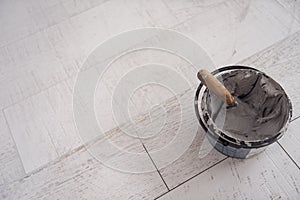 Ceramic wood effect tiles and tools for tiler on the floor