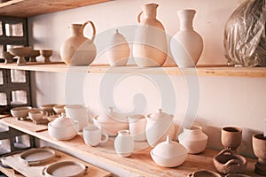 Ceramics, dishes and pottery on shelf in studio, creative store and manufacturing startup. Clay products, background and
