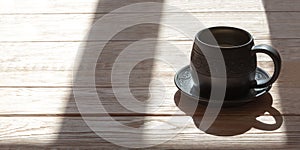 Ceramics handmade mug with milk over wooden background