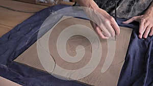 Ceramist creates a pattern and relief dolly shot