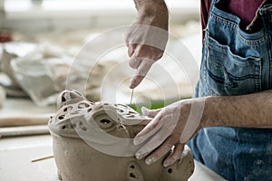 Ceramist Dressed in an Apron Sculpting Statue from Raw Clay in Bright Ceramic Workshop.