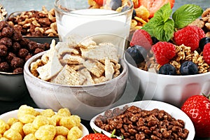 Cereal. Bowls of various cereals, berries and milk for breakfast. Muesli with kids cereals