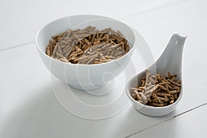 Cereal bran sticks in bowl and spoon