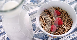 Cereal bran sticks with raspberries in a bowl 4k