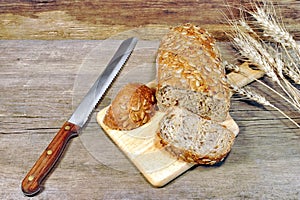 Cereal Bread Loaf with Grains and slicer knife in rustic still-life, XXXL