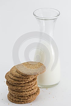 Cereal cookies and milk bottle on white background