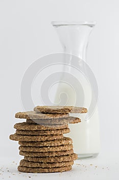 Cereal cookies and milk bottle on white background