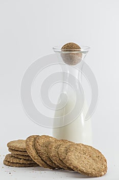 Cereal cookies and milk bottle on white background
