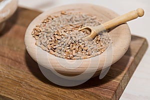 Cereal grains in wooden bowl