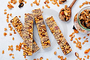 Cereal granola bar with nuts, fruits and berries on a whhite stone table. Granola bar. Healthy snack.