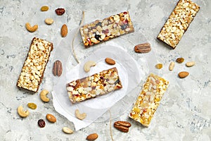 Cereal granola bars with nuts and dry berries on a white background. Top view healthy snack.