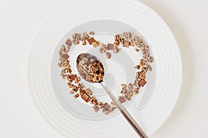 Cereal muesli breakfast and spoon on white background. Healthy eating and lifestyle concept