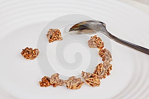 Cereal muesli breakfast and spoon on white background. Healthy eating and lifestyle concept