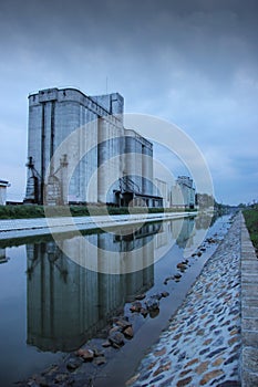Cereal silo with water reflection in Bega river