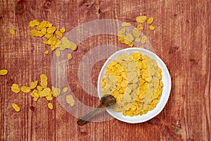 Cereal in a white bowl on wooden background