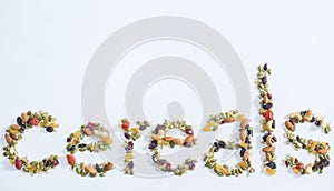 Cereal word made of dried fruits and nuts on white background
