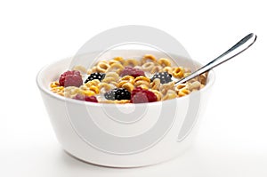 Cereals blackberries raspberries and milk in a bow