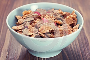 Cereals in blue bowl on brown