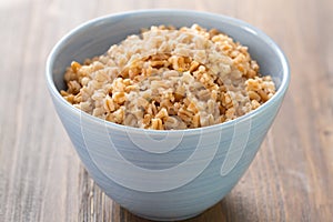 Cereals in bowl on brown background