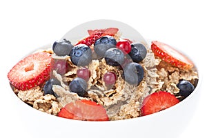 Cereals bowl with red fruits isolated on white