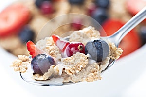 Cereals bowl with red fruits on white