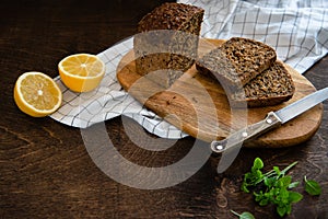 Cereals bread with seeds baked at home, bio ingredients, healthy nutrition. Sliced rye bread on cutting board. copy space