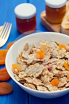 Cereals with dry fruits in bowl and jam