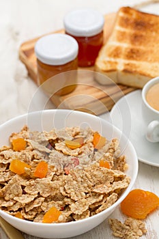 Cereals with dry fruits in bowl and jam
