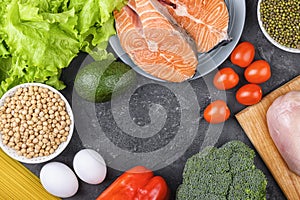 Cereals, fish, eggs, cheese and vegetables on a black background, flat lay. The concept of proper nutrition, flexitarian