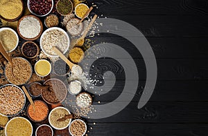 Cereals, grains, seeds and groats black wooden background