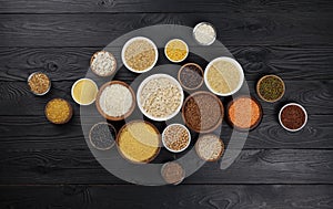 Cereals, grains, seeds and groats black wooden background