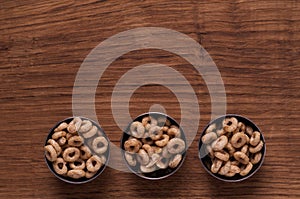 Cereals in metal bowl on brown wooden table