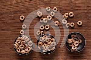 Cereals in metal bowl on brown wooden table