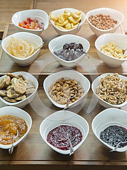 Cereals, nuts and jams in bowls