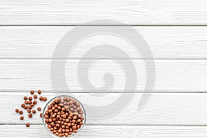 Cereals, oatflakes and cornflakes for healthy breakfast on white wooden background top view mock up photo